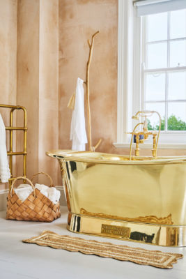 Bathroom with gold bathtub