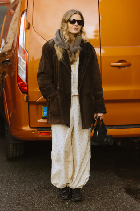 Woman stood in front of orange van