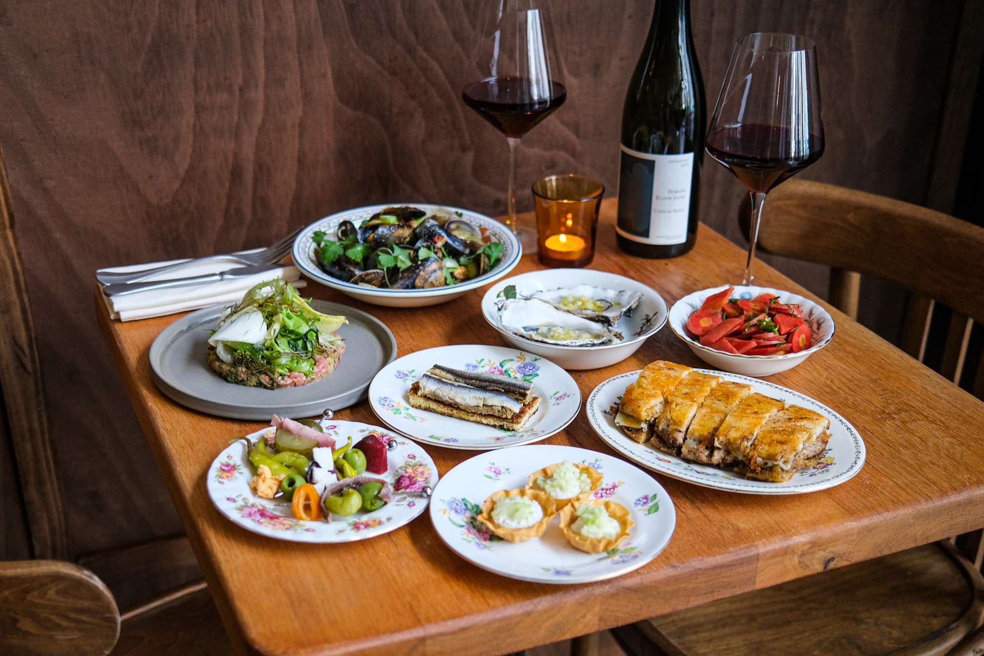 Plates of food and wine on a table in a restarurant