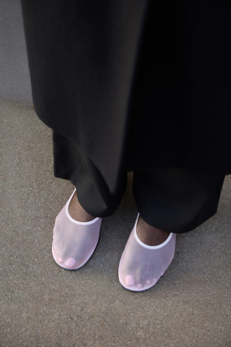 Feet in pink mesh ballet flats