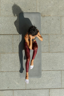 Woman doing a sit up outside