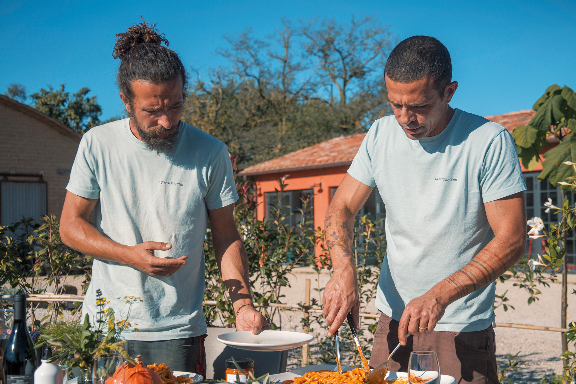 Two men serving up food on a farm
