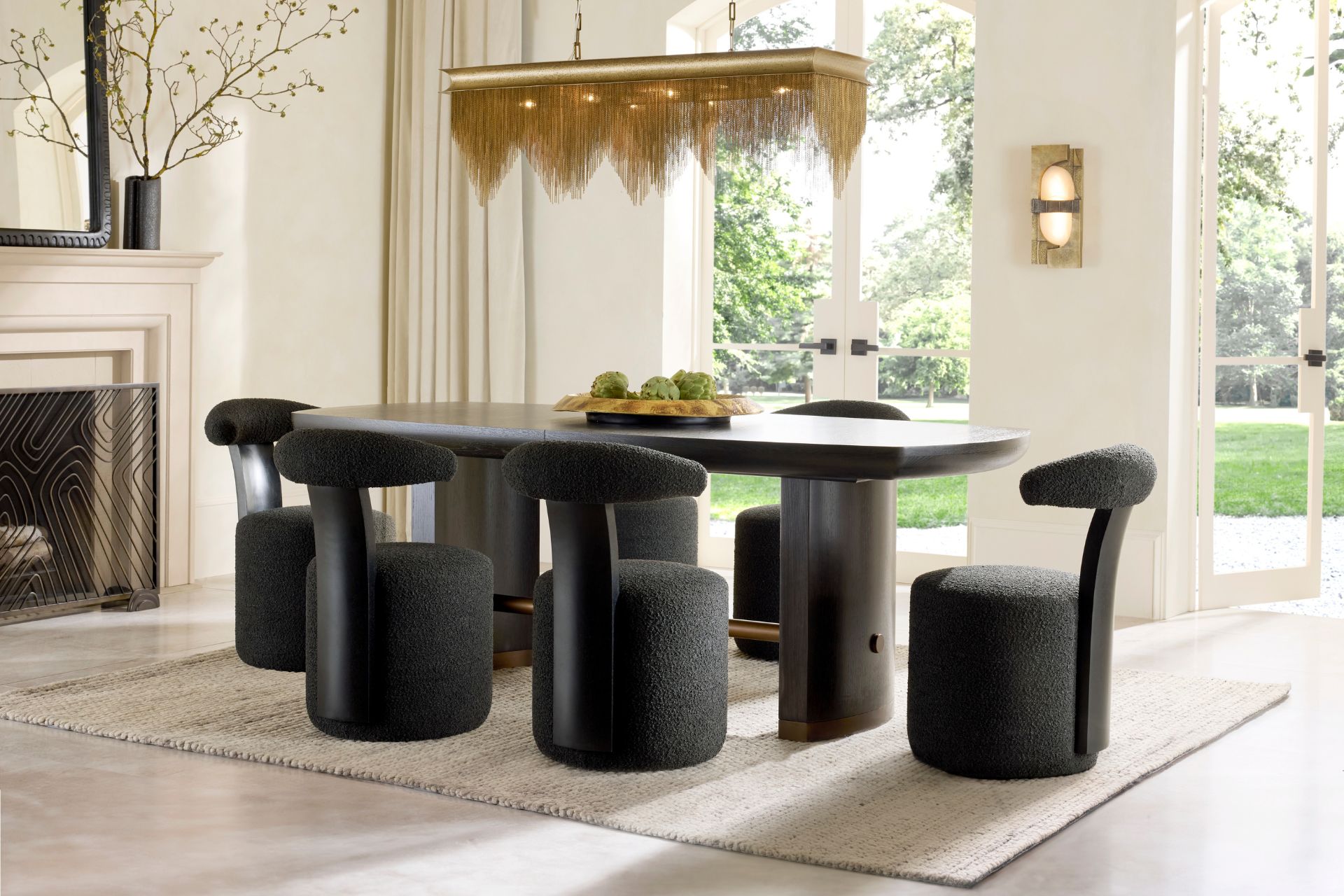 Modern dining space with curved black chairs and a gold statement light