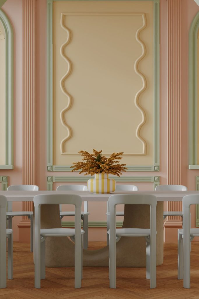 Dining room with white furniture, pastel yellow walls with scalloped panelling, and pink trim.