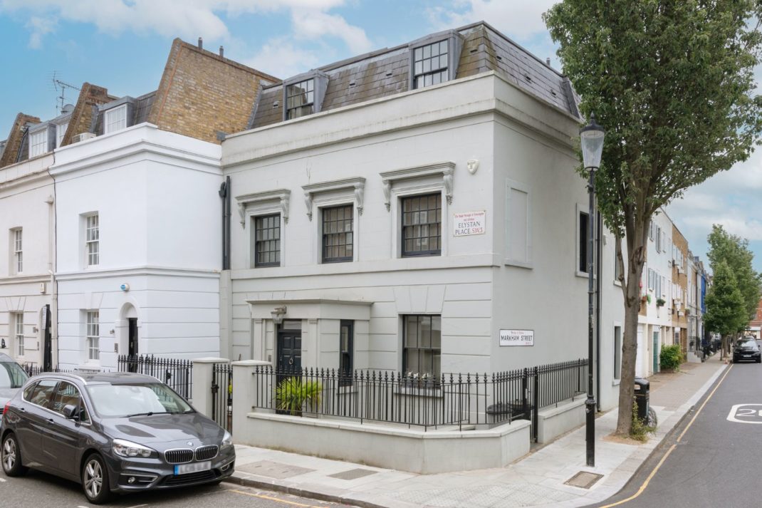 Double fronted, end-of-terrace Chelsea home with black railings