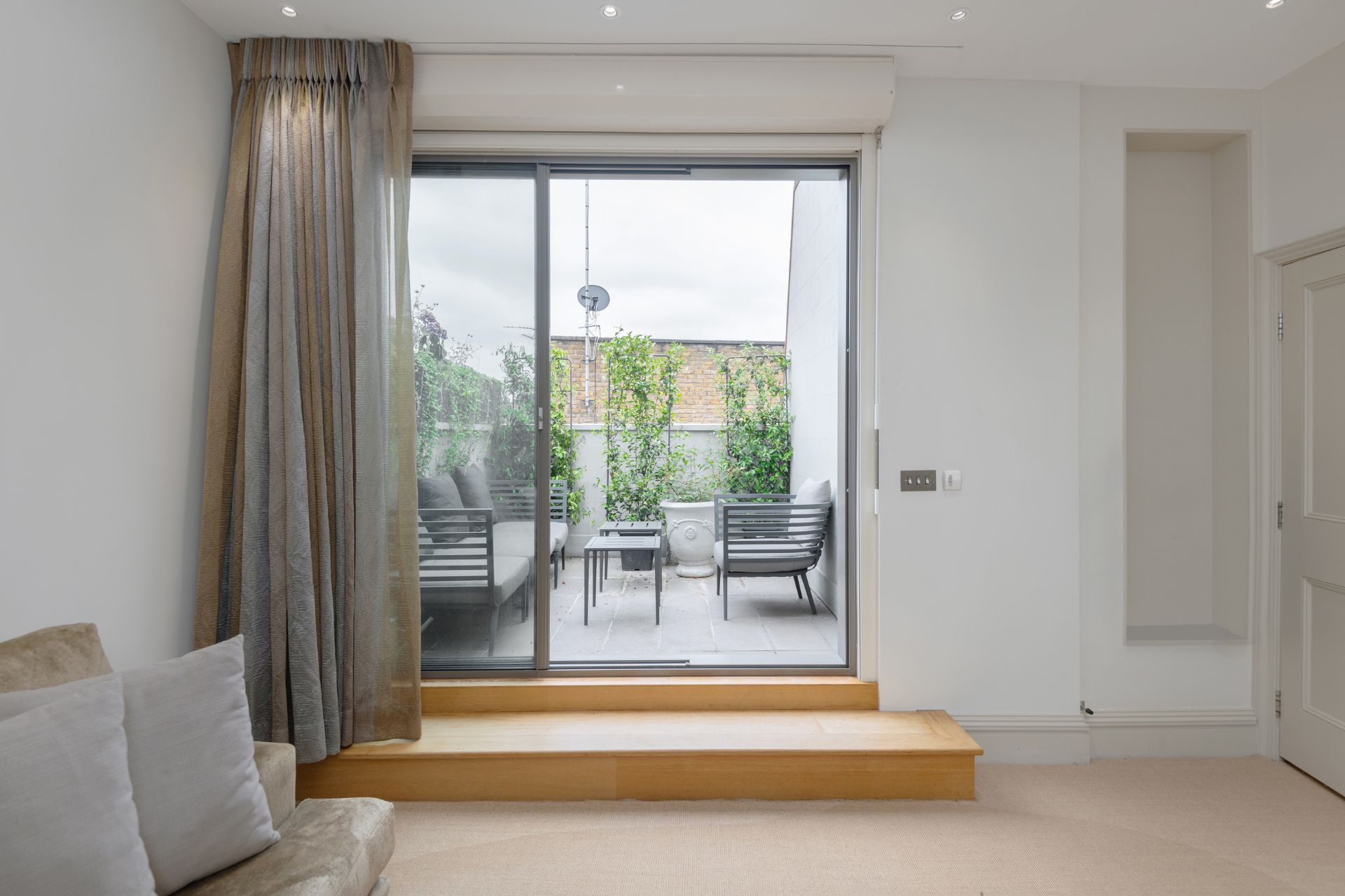 Top-floor living room leading onto a large roof terrace.