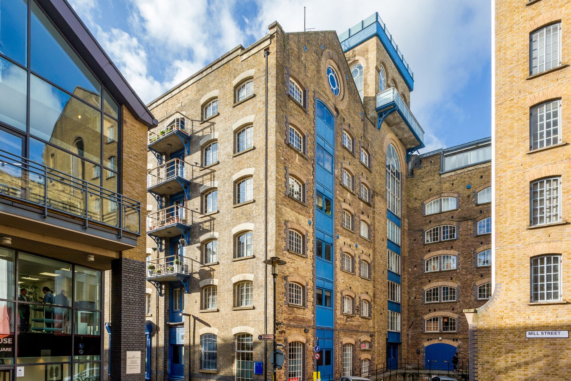 Exterior of converted Victorian warehouse with blue wooden doors