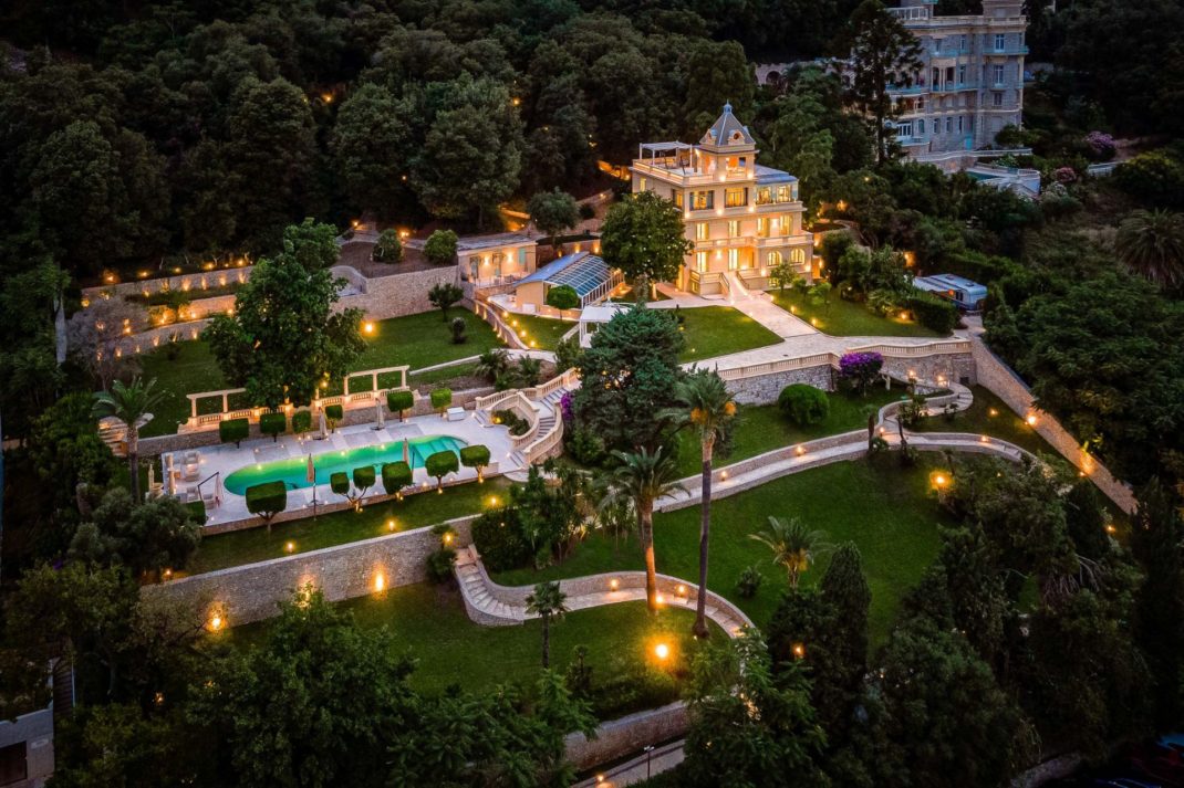 Aerial view of villa on the French Riviera, with an outdoor pool, landscaped gardens and large terraces.