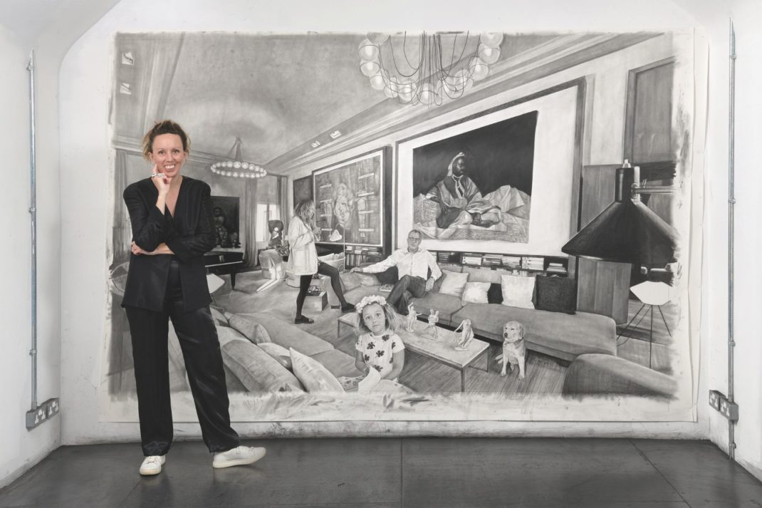Nina Mae Fowler standing in front of one of her charcoal drawings.