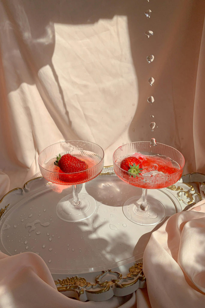 Two pink mocktails with strawberries