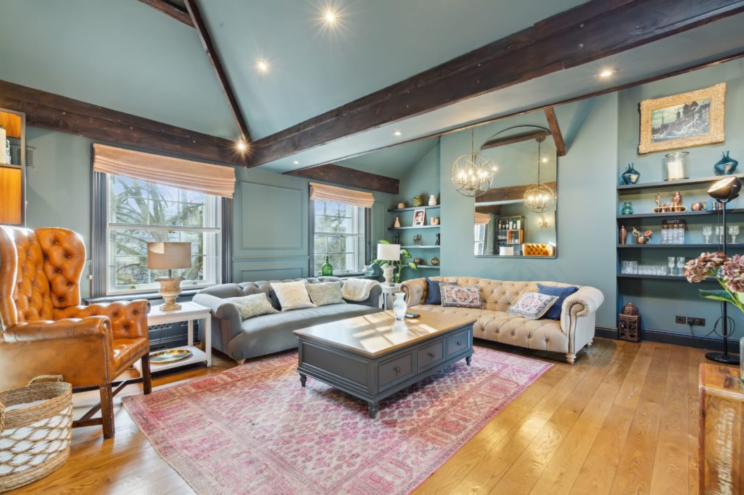 Duck egg blue living room with ceiling beams, hardwood floors and large windows