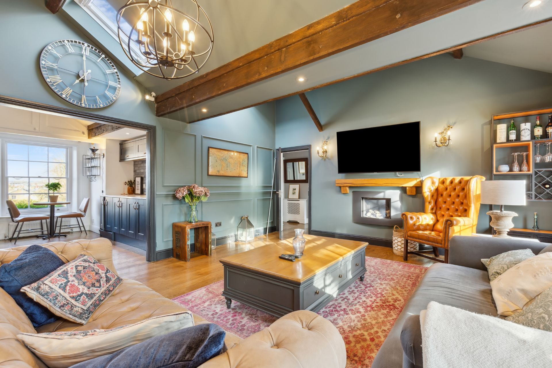 Duck egg blue living room with wooden ceiling beams, cream sofas and wooden floors