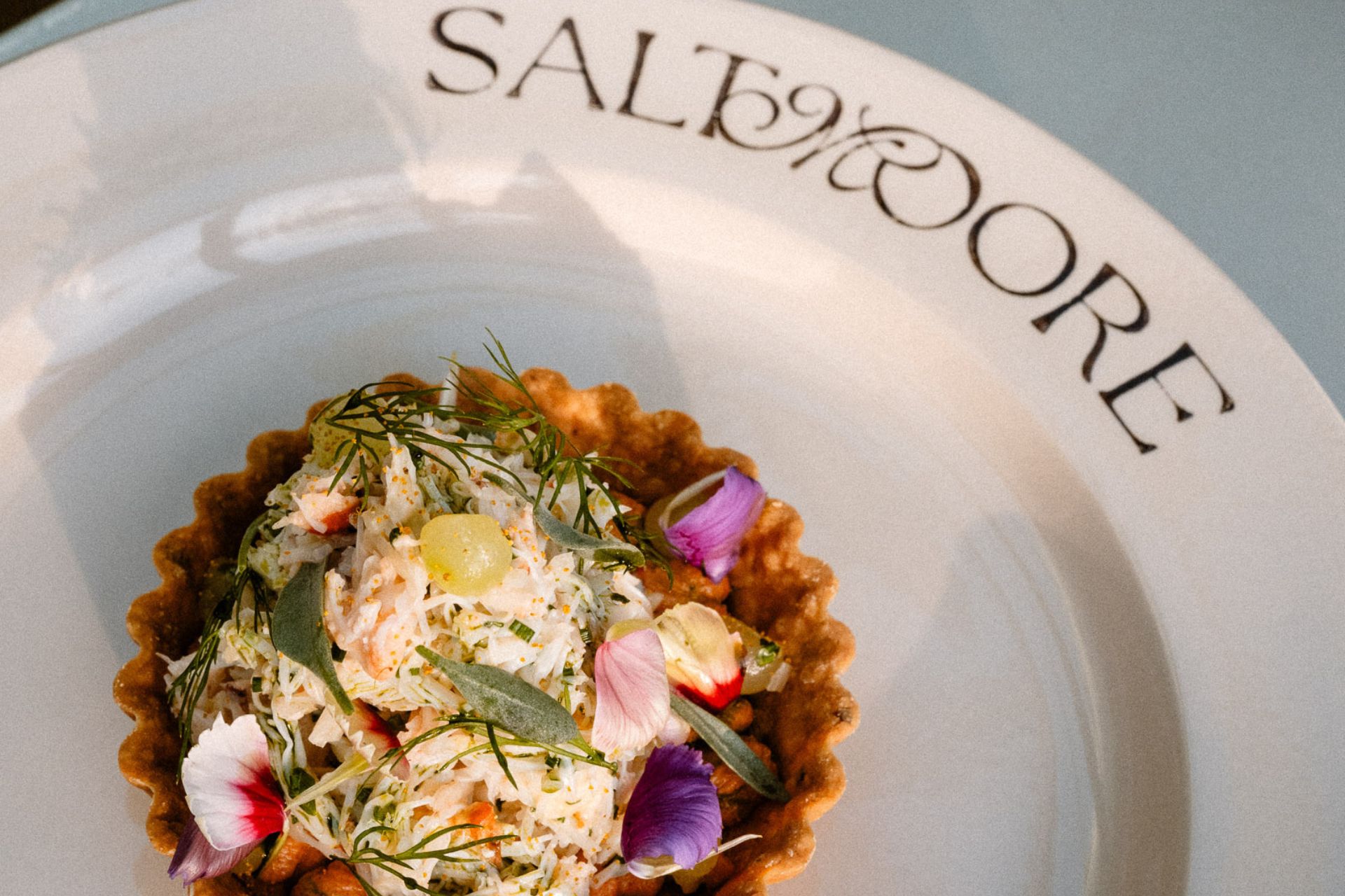 Scalloped vegetable tart with edible flowers