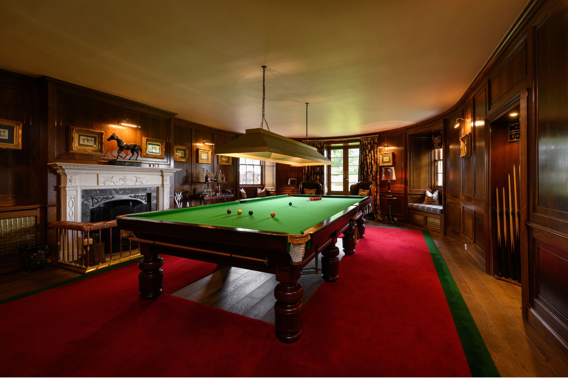 Castle billiards room with red carpeted floors and oak panelled walls