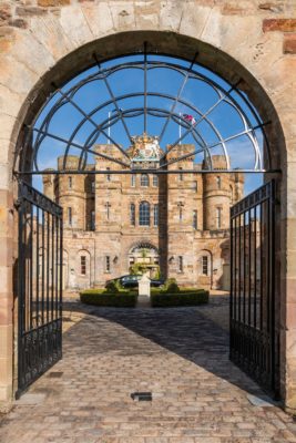 Arched gateway leading to a Neoclassical brick castle