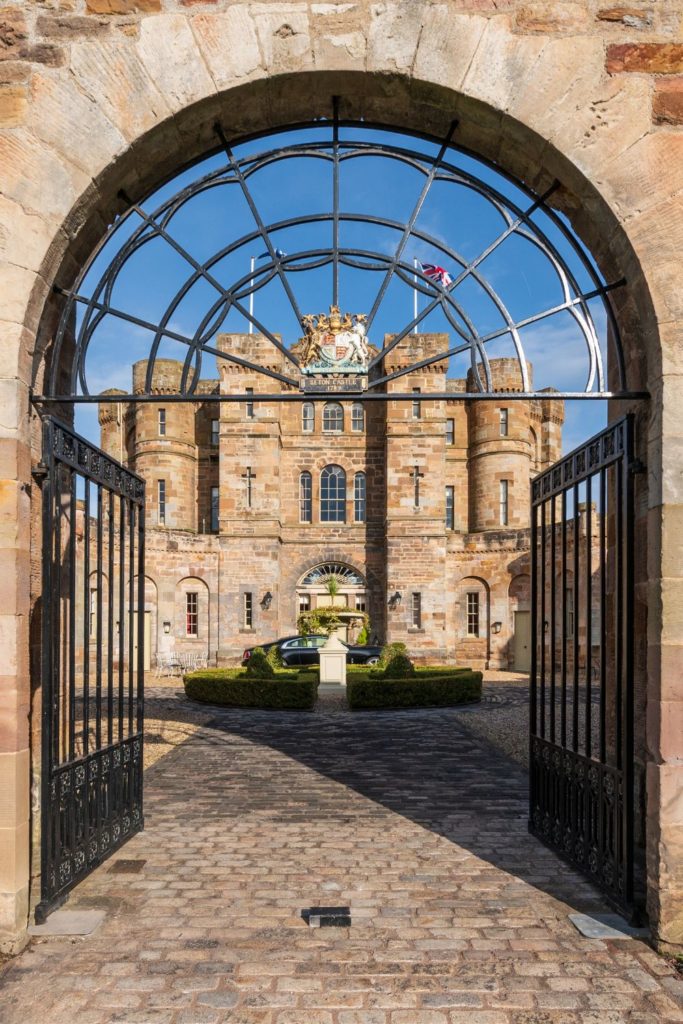 Arched gateway leading to a Neoclassical brick castle