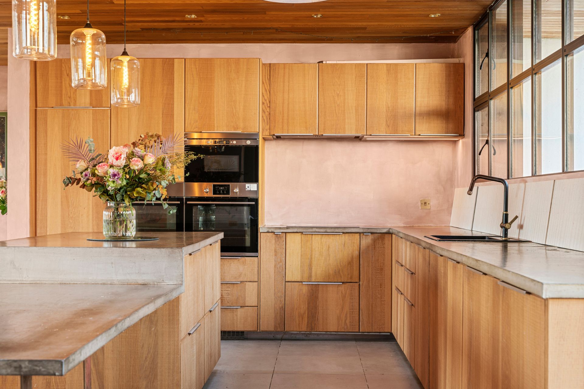 Kitchen with oak cabinets, granite worktops and pale pink walls
