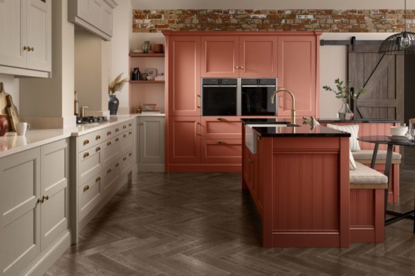 Kitchen with pale taupe cabinets and a peach-pink wall unit with a built-in oven.