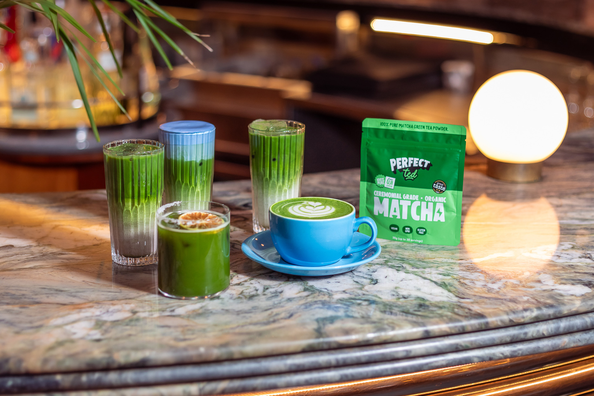 Matcha lattes on the counter at a cafe