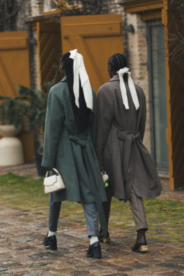 Woman walking with white bows in their hair | spring hair trends 2025