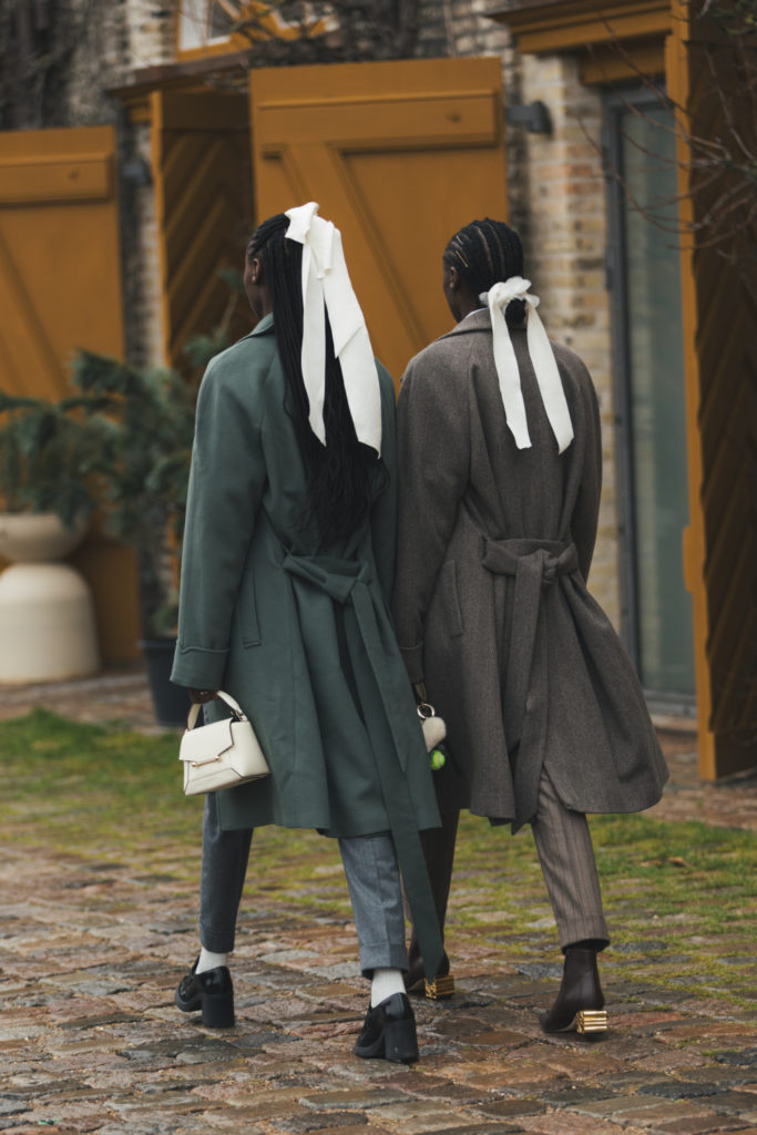 Woman walking with white bows in their hair | spring hair trends 2025