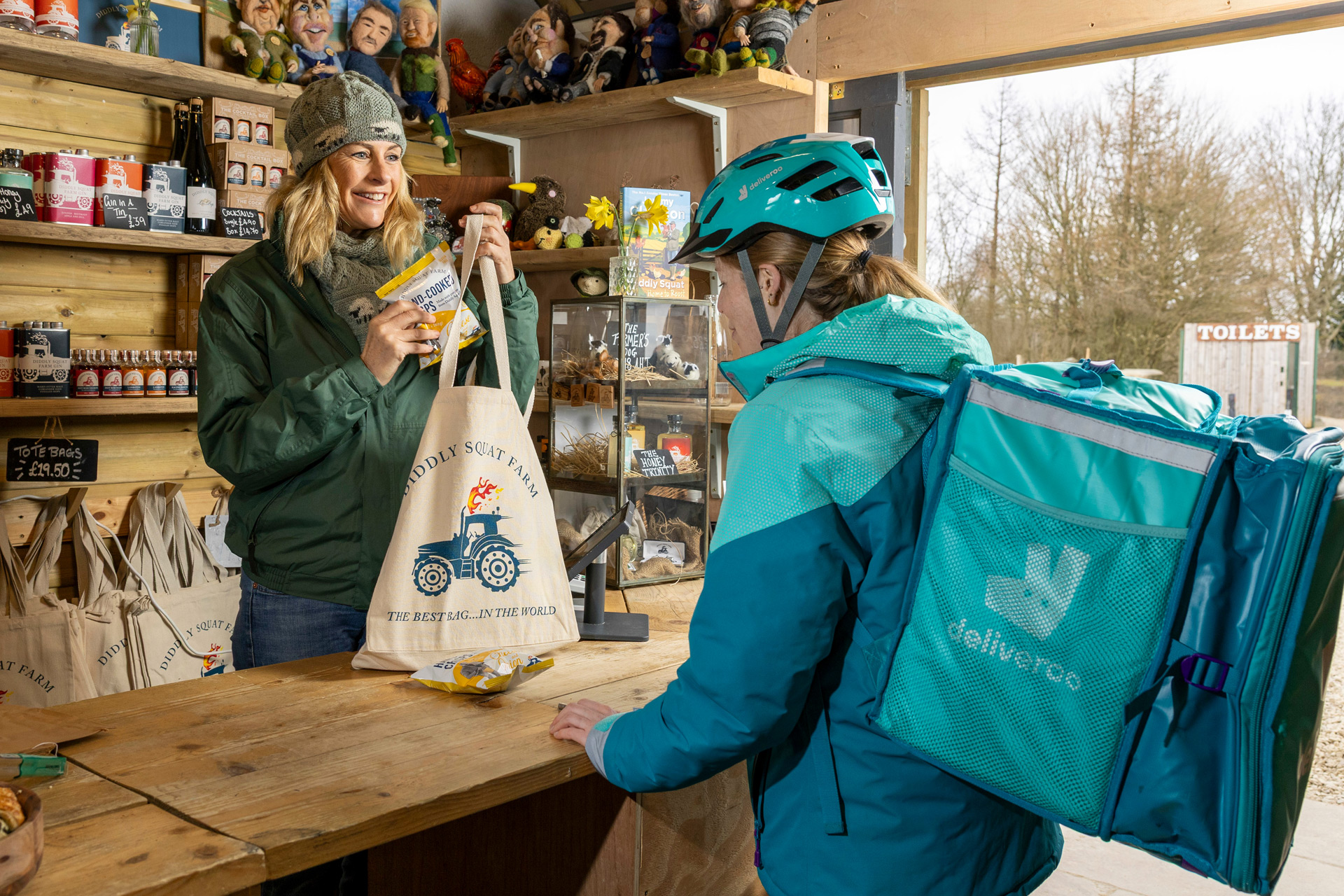 Lisa Hogan giving a Deliveroo driver items