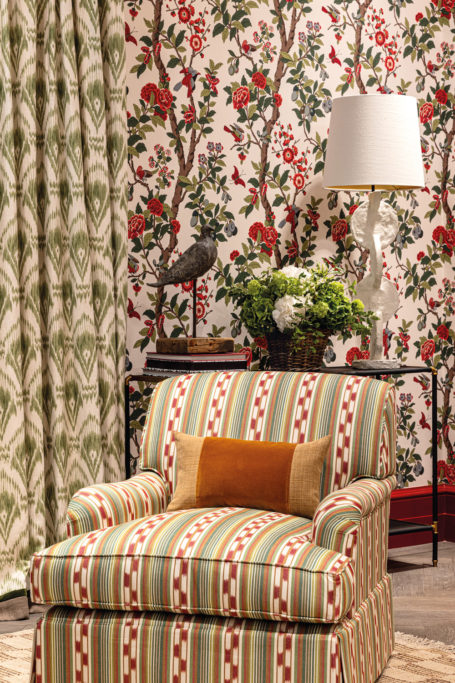 An armchair and patterned wallpaper