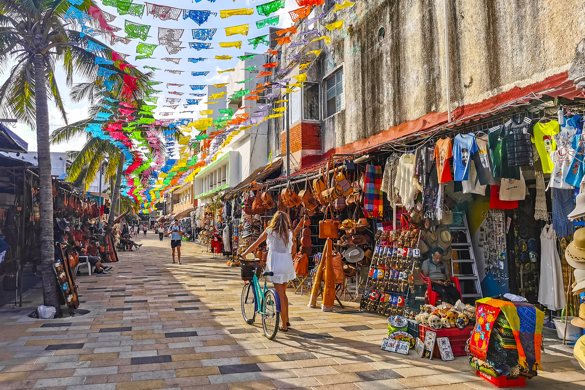 Typical street road and cityscape of La Quinta Avenida with restaurants shops stores people souvenirs and building in Playa del Carmen Playa del Carmen Quintana Roo Mexico.