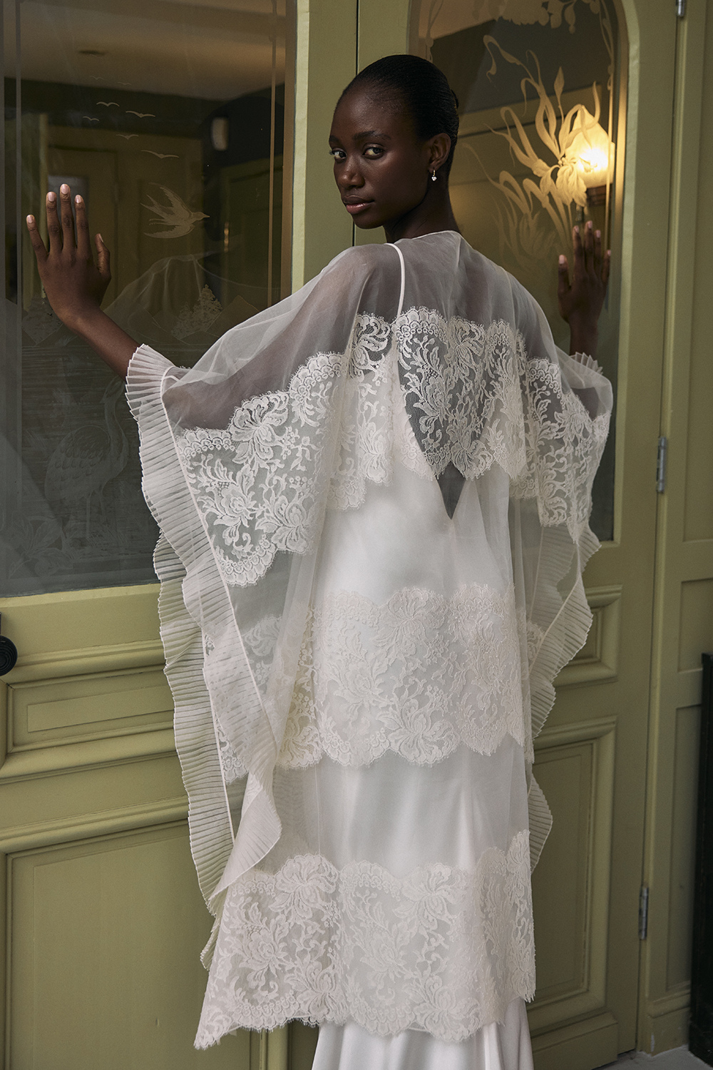 Woman wearing wedding dress and cape