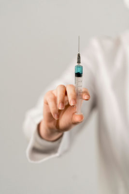 Hand holding needle | Botox age guide