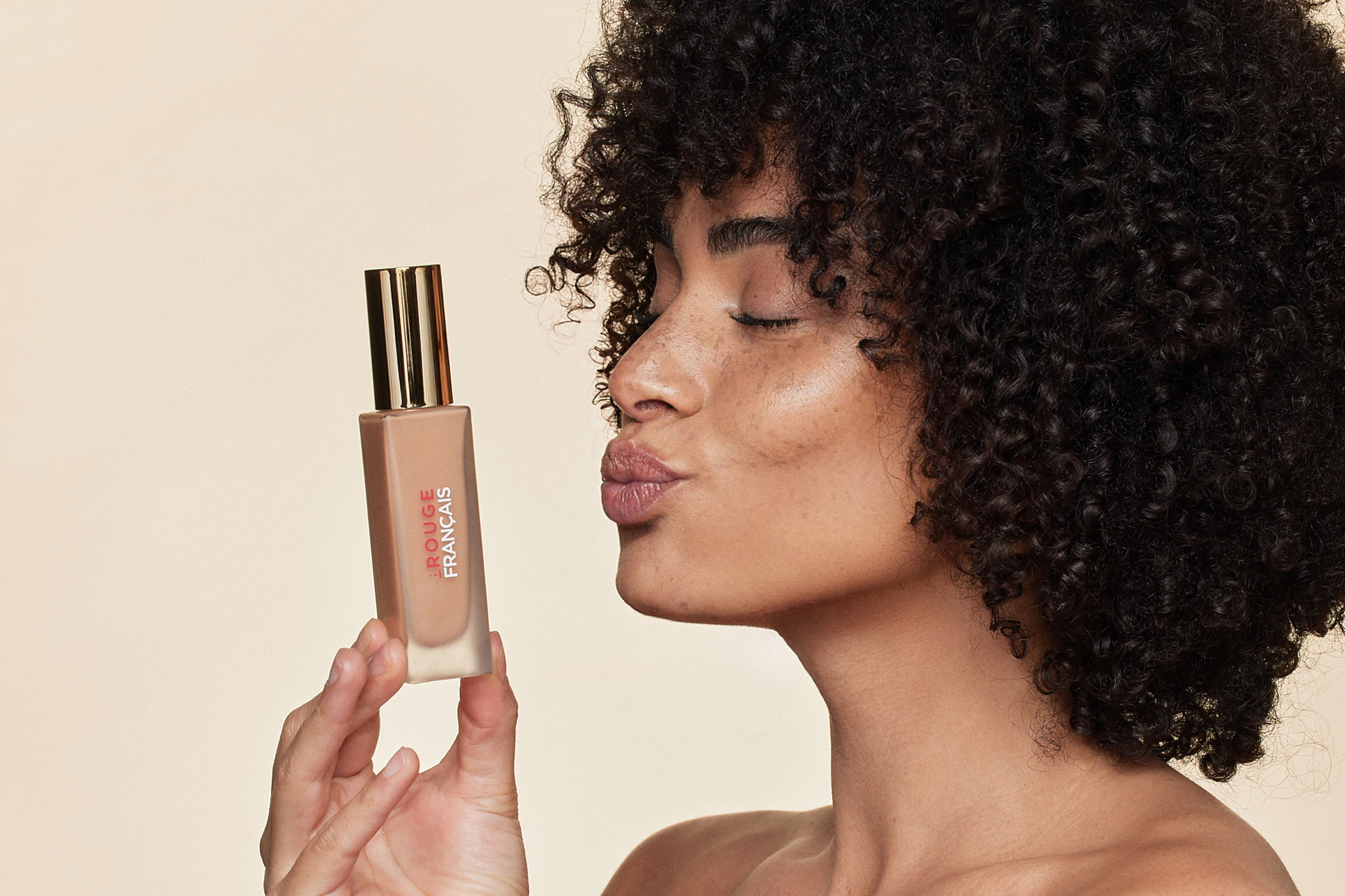 Woman with foundation bottle