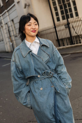 Woman with choppy bob and denim trench coat