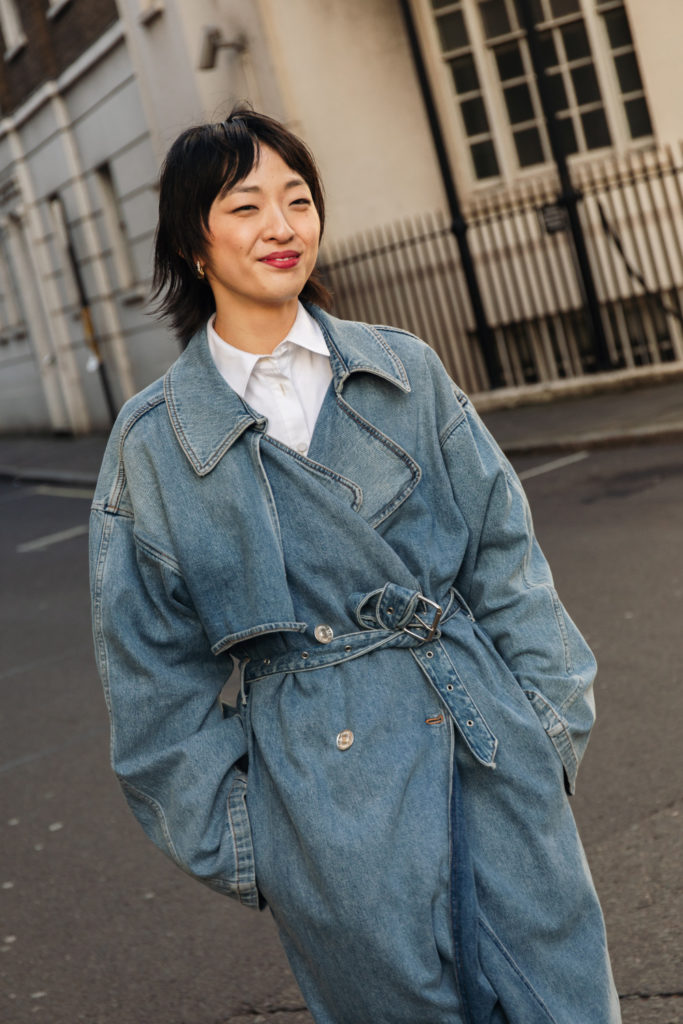 Woman with choppy bob and denim trench coat