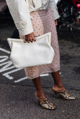 Close up of woman holding bag | fashion podcasts