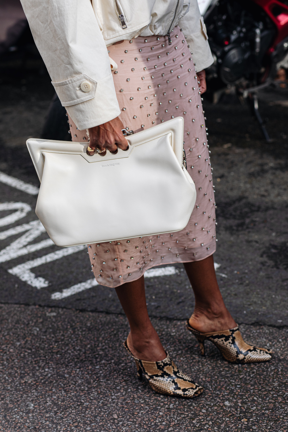 Close up of woman holding bag | fashion podcasts