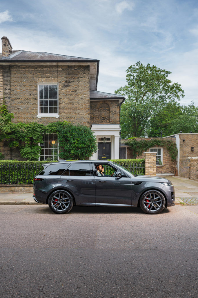 A luxury car beside a property