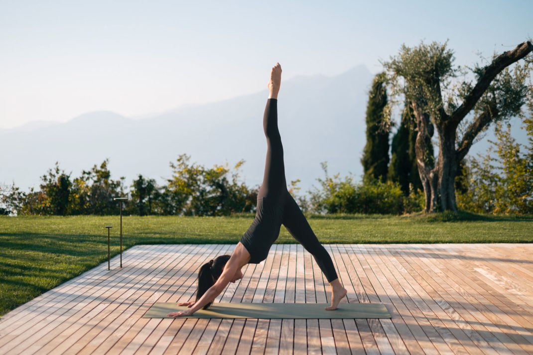 A woman doing a yoga pose at the Cape of Senses