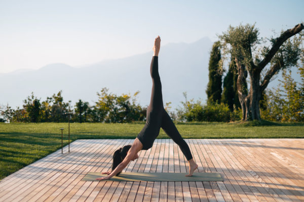 A woman doing a yoga pose at the Cape of Senses