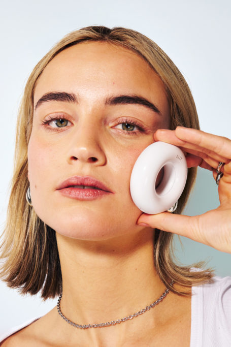 Woman holding ZIIP Dot to face