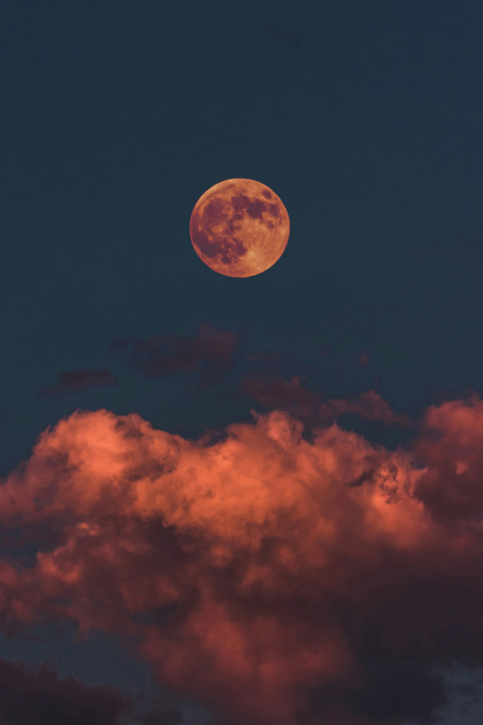 A full moon with a reddish hue