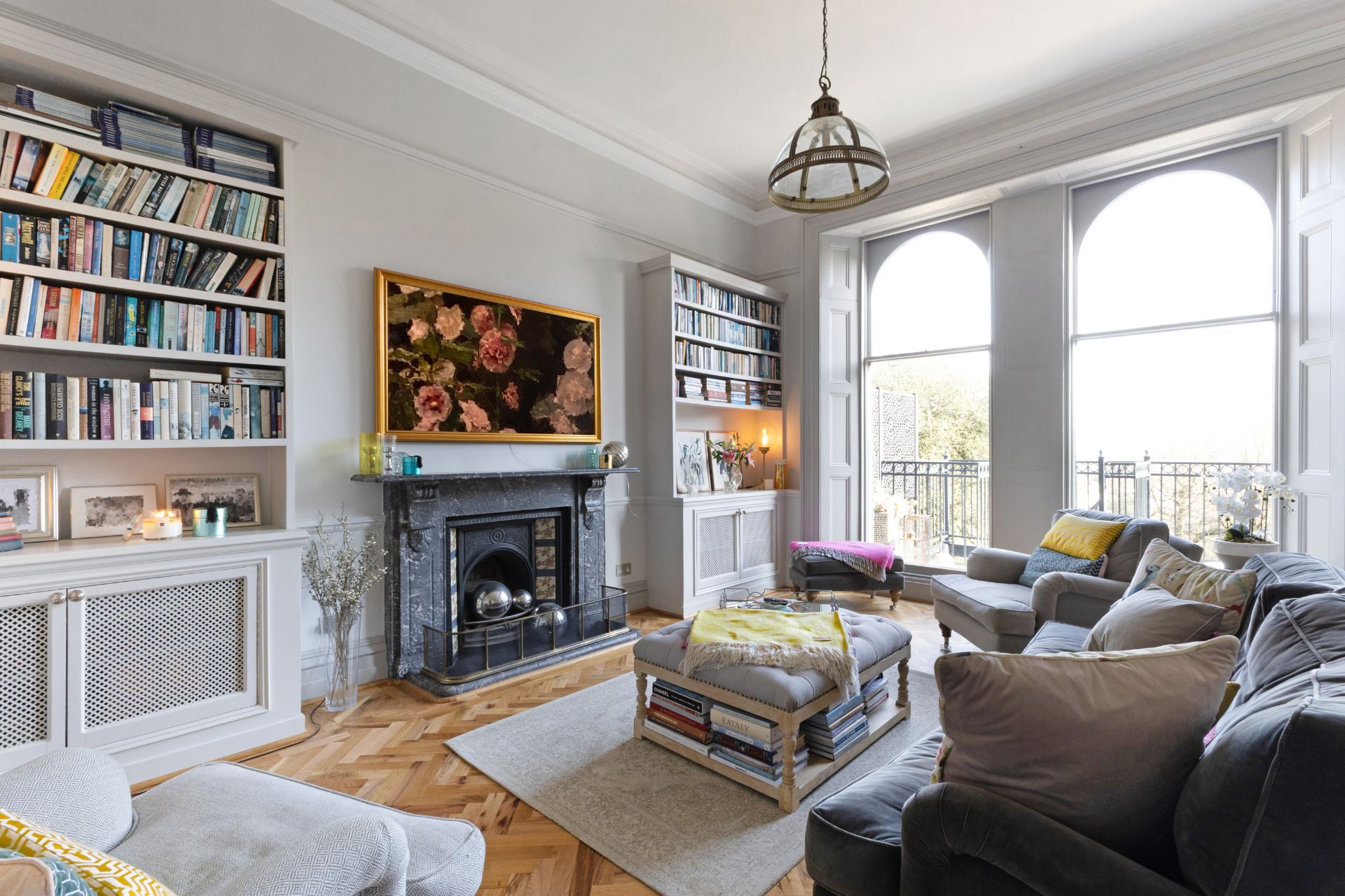 Living room with oak parquet flooring, marble fireplace and arched sash windows