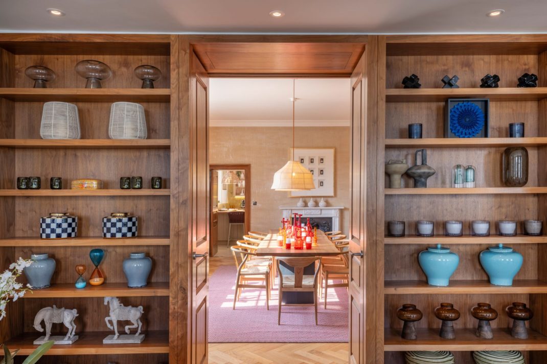 Dining room with built-in wooden shelves and a pale purple rug