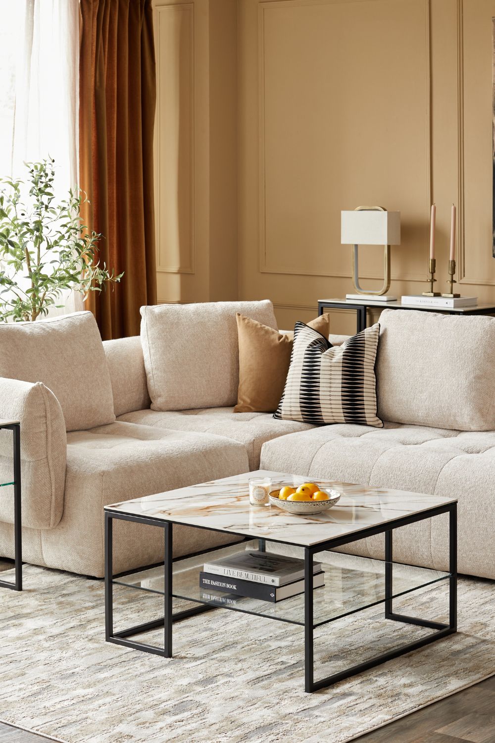 Taupe living room with cream corner sofa and white marble coffee table with black frame