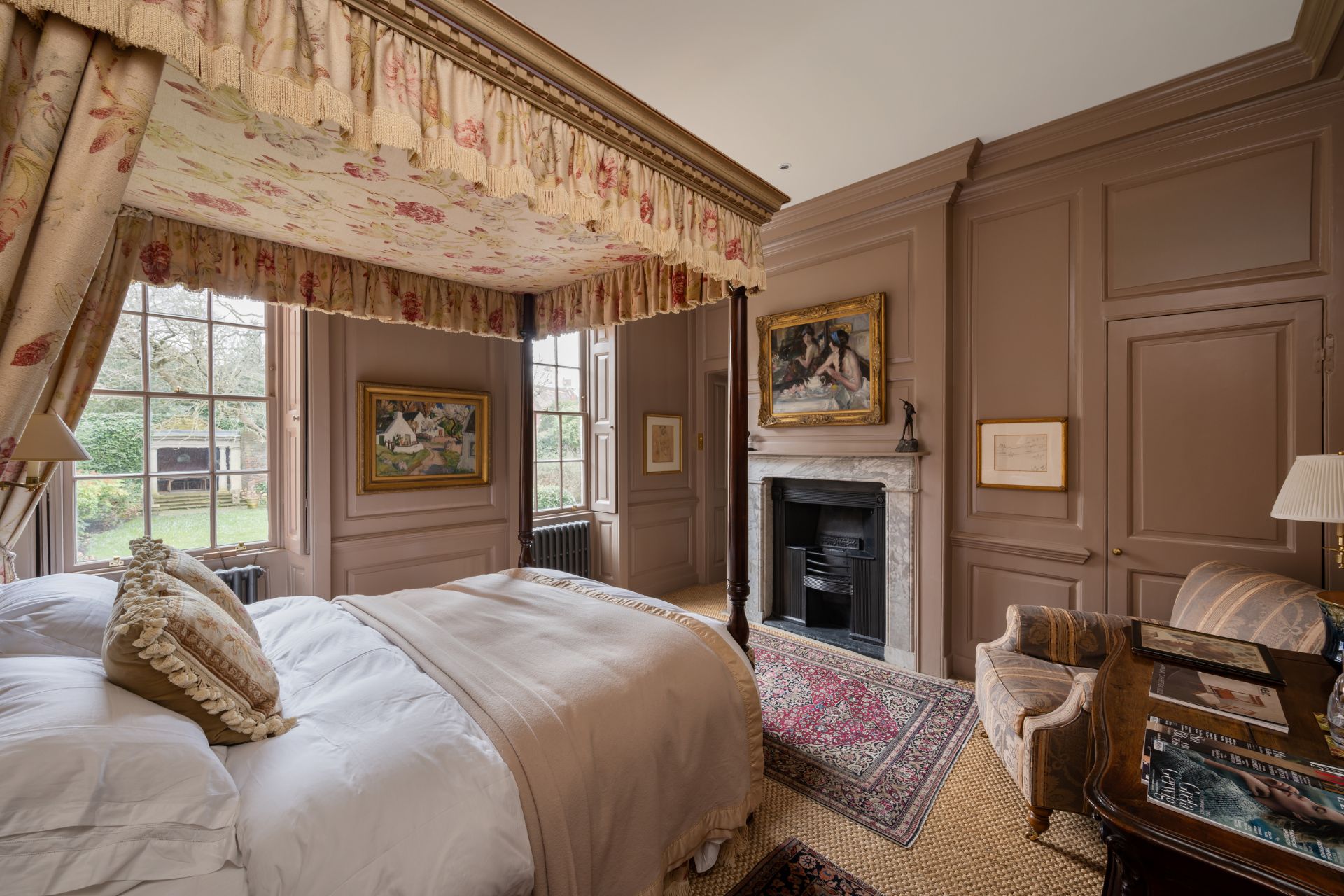 Bedroom with taupe walls, a four poster bed and a marble fireplace