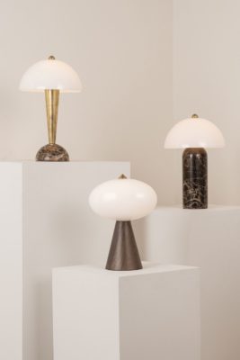 Set of three portable lamps on white plinths