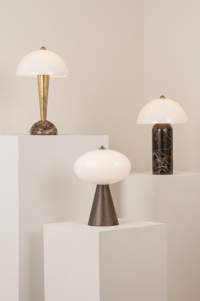 Set of three portable lamps on white plinths