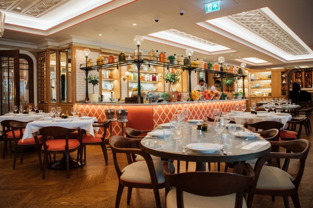 Restaurant with rose pink tiled bar and white marble-topped tables