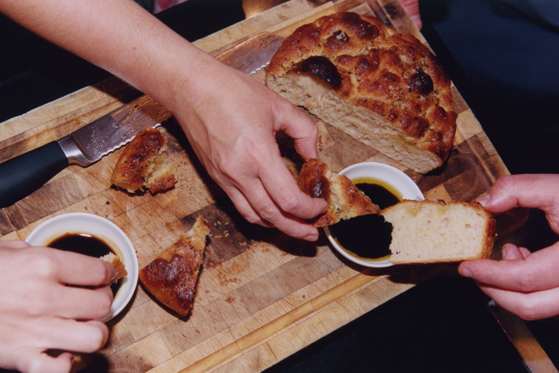 Chefs sharing freshly made focaccia