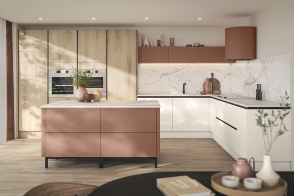 Kitchen with dusty pink cabinets, pale wooden wall cabinets and veined white marble worktops
