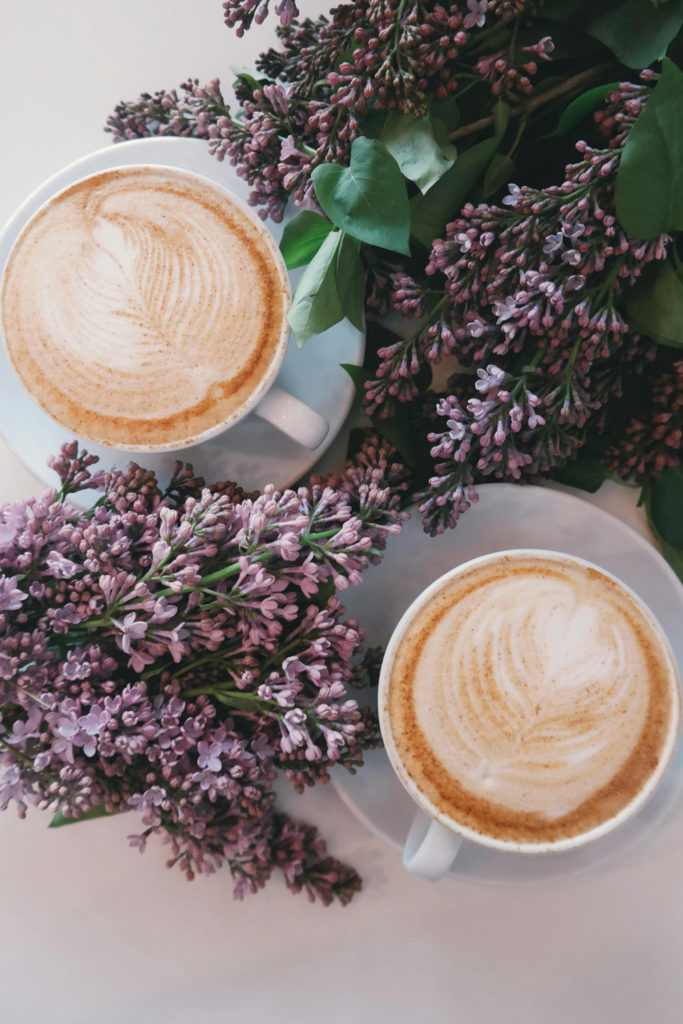 Two cups of coffee with flowers